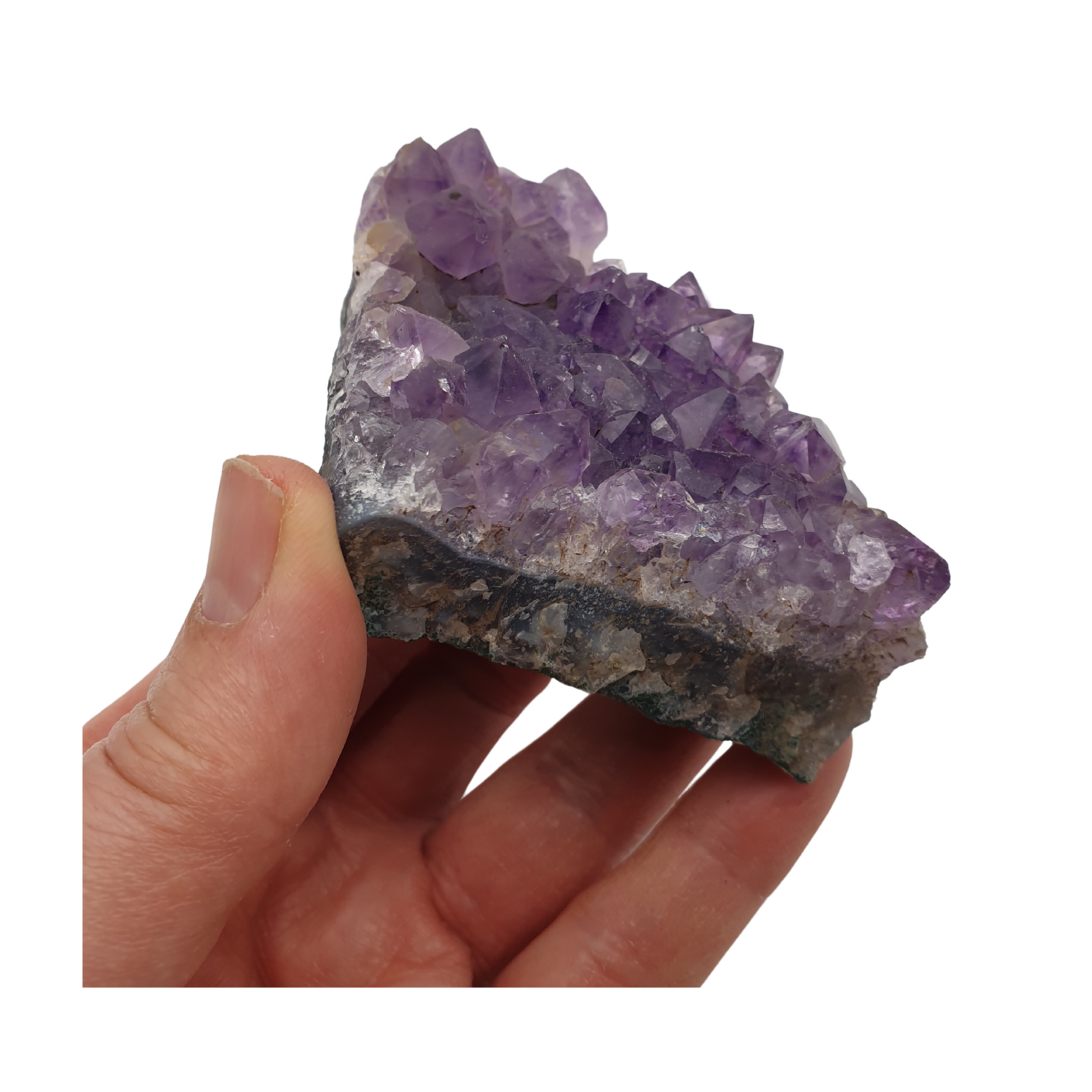 A hand holding a piece of amethyst with purple points on a base of grey stone