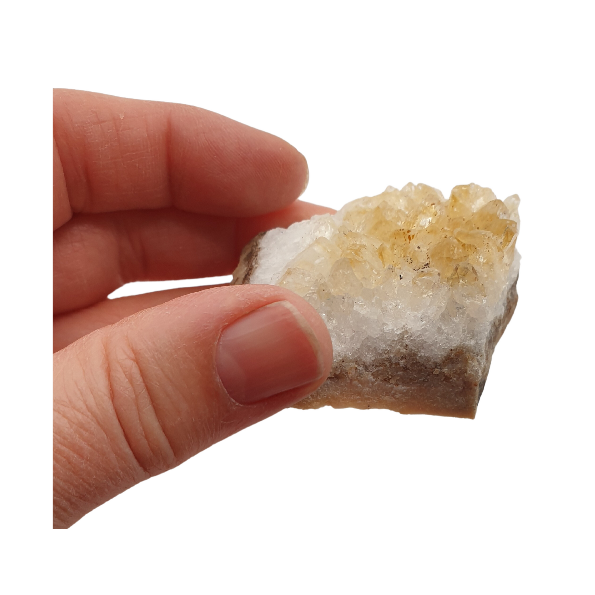 A hand holding a piece of citrine with yellow points and a white base