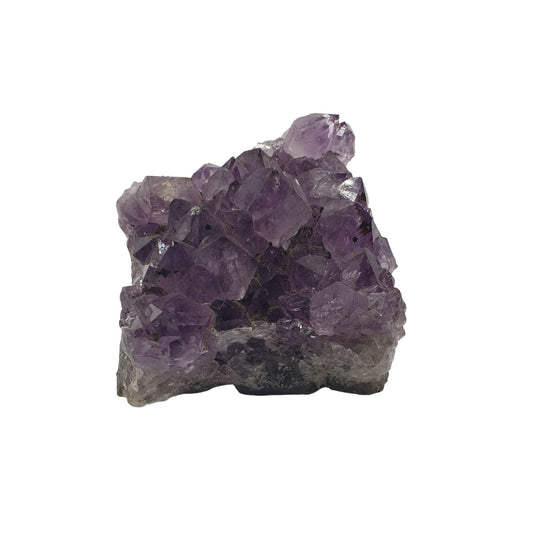 A piece of amethyst with purple points on a base of grey stone