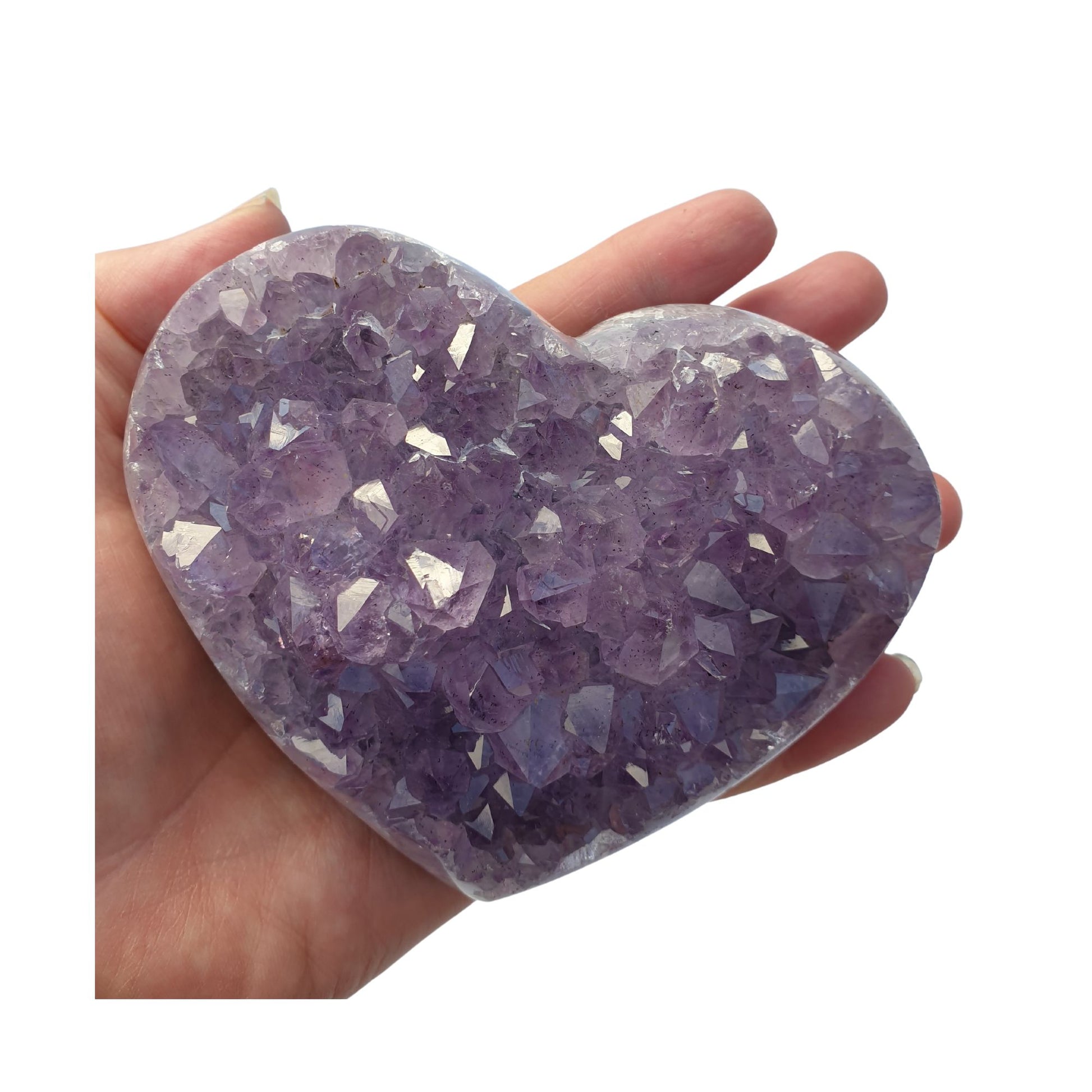 A hand holding a large heart shaped Amethyst cluster with purple points